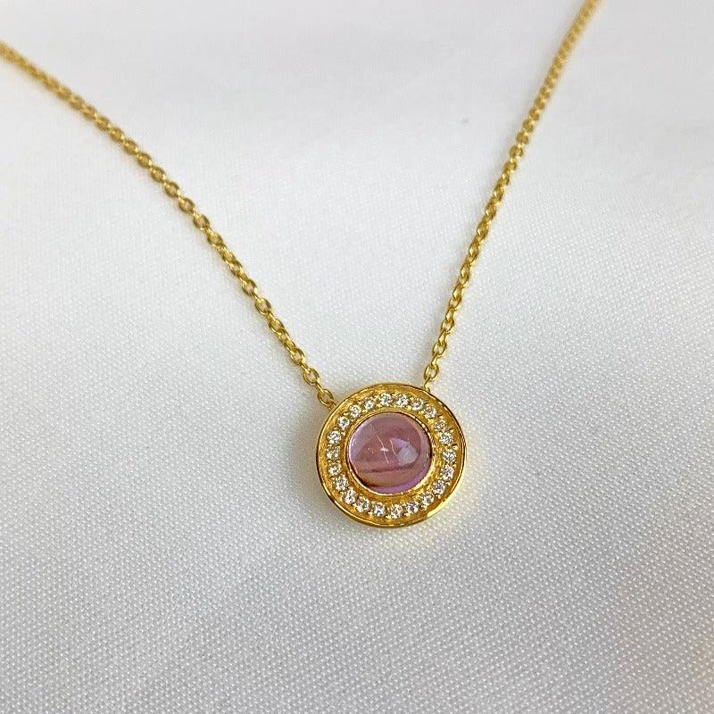 Our exquisite 18-carat Yellow Gold-plated Sterling Silver pendant is a captivating tribute to the elegance of the Regency era and the enchanting world of Jane Austen. This stunning pendant features a mesmerising amethyst in a cabochon cut, gracefully surrounded by shimmering cubic zircons.