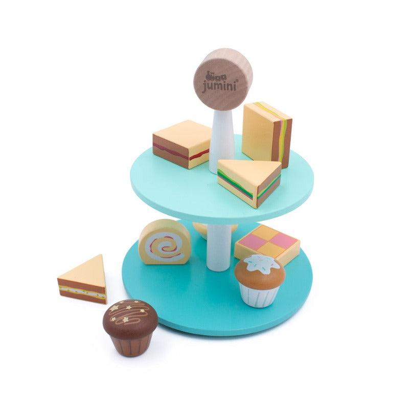 the wooden tea set is clearly displayed on a white background to show the colourful blue cake stand and the 9 pretend cakes and sandwiches. 