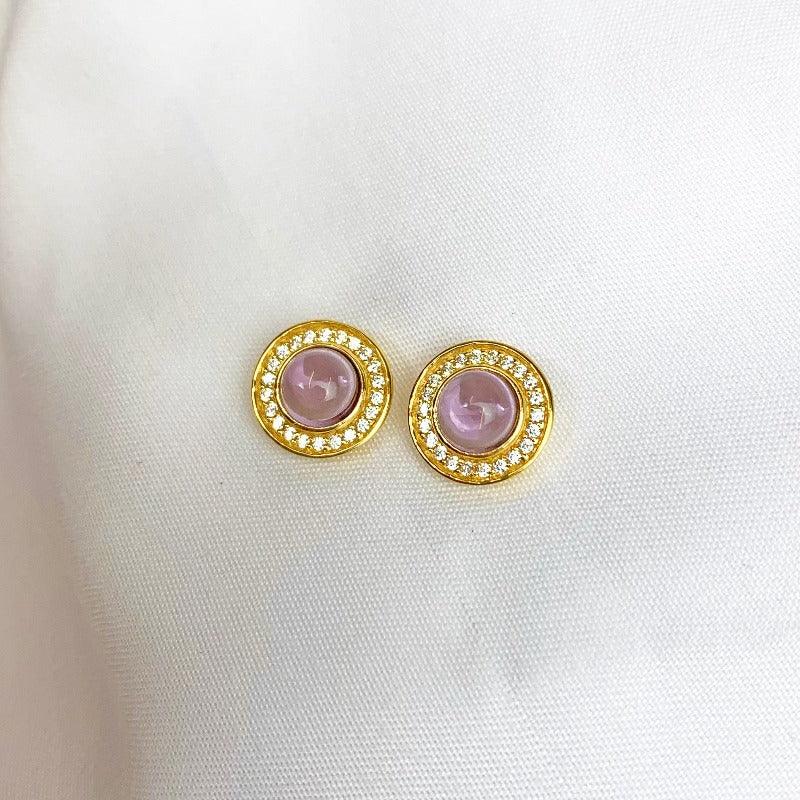 Our exquisite 18 carat Yellow Gold Plated Sterling Silver Earrings, a mesmerising ode to the beloved world of Jane Austen and the regal elegance of the Regency era.  These stunning earrings feature a captivating Amethyst in a cabochon cut, delicately encircled by sparkling cubic zircons.