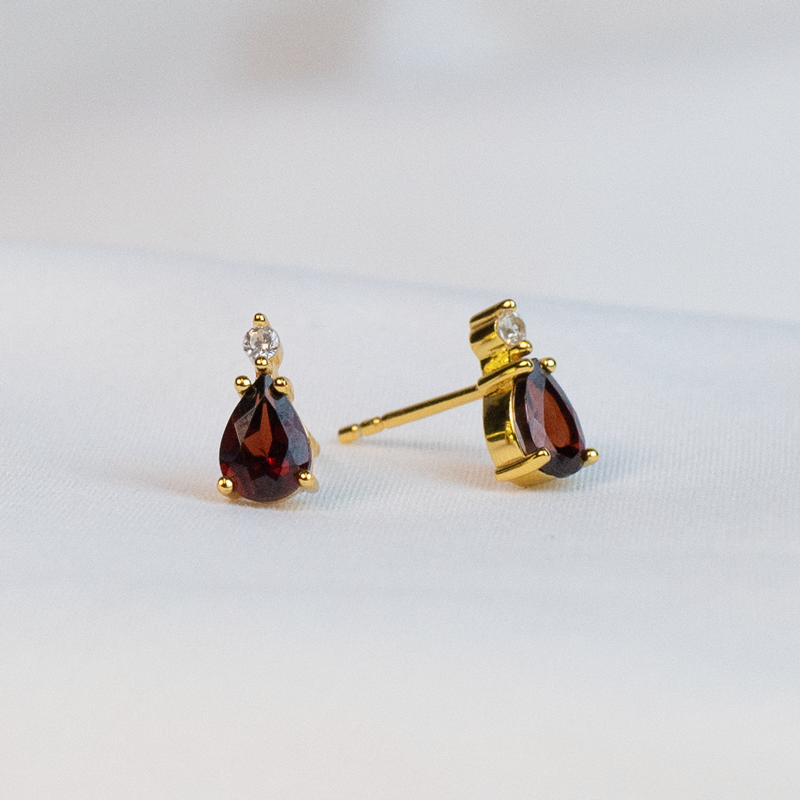 Embrace your inner Elizabeth Bennet with these elegant Garnet Earrings! Crafted from gold plated sterling silver, these Elizabeth Bennet Garnet Drop Earrings are perfect for any "obstinate, headstrong girl" out and about!