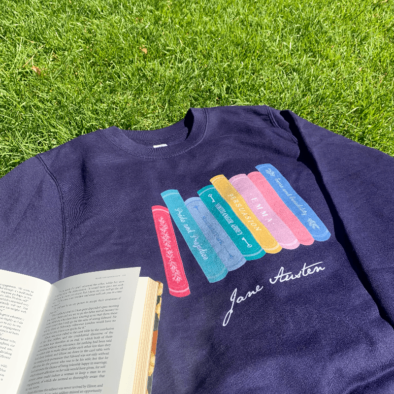 Made from a soft blend of 80% cotton and 20% polyester, the adorable design illustrates all of Jane Austen completed novels, from Pride & Prejudice to Persuasion.   Available in Navy Blue, this Jane Austen Sweater makes a thoughtful gift for any lover of Jane Austen's novels and characters. 