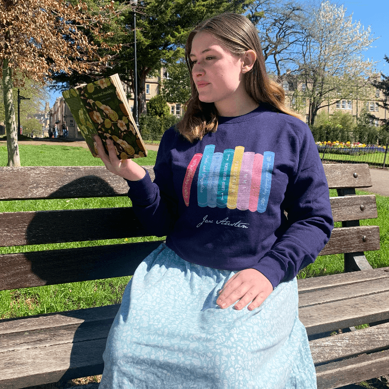 Made from a soft blend of 80% cotton and 20% polyester, the adorable design illustrates all of Jane Austen completed novels, from Pride & Prejudice to Persuasion.   Available in Navy Blue, this Jane Austen Sweater makes a thoughtful gift for any lover of Jane Austen's novels and characters. 