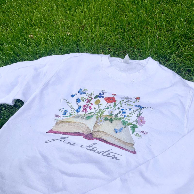 Wear Jane Austen's iconic signature with our beautiful blossoming books design sweater.   Made from a soft blend of 80% cotton and 20% polyester, the modern design compliments the wondrously classical novels that Jane Austen is famous for. 