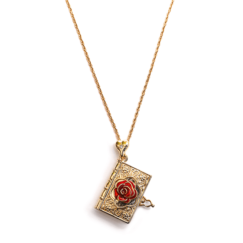 The Rose Bud Locket is shown here with beautiful. It has a long gold chain with a hanging gold book decorated with a red rose on the outside. This makes a lovely gift for any jane austen or romance fan.