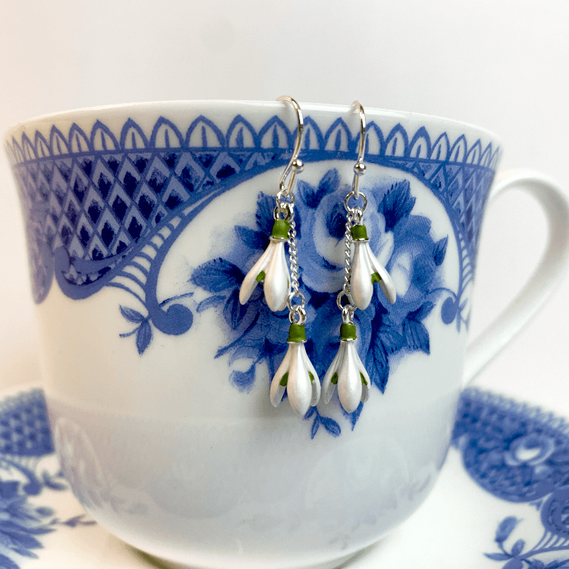 snow drop earrings displayed on a vintage regency teacup to show their regency style 